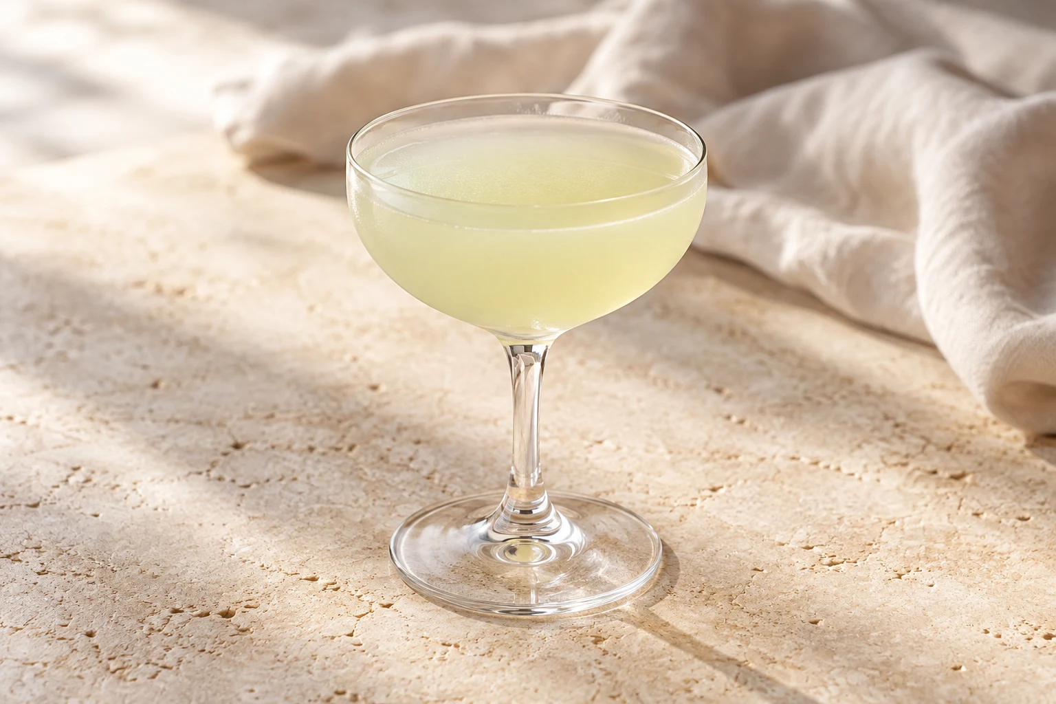 Pale muted yellow-green Last Word cocktail in a small stemmed coupe, without ice or garnish