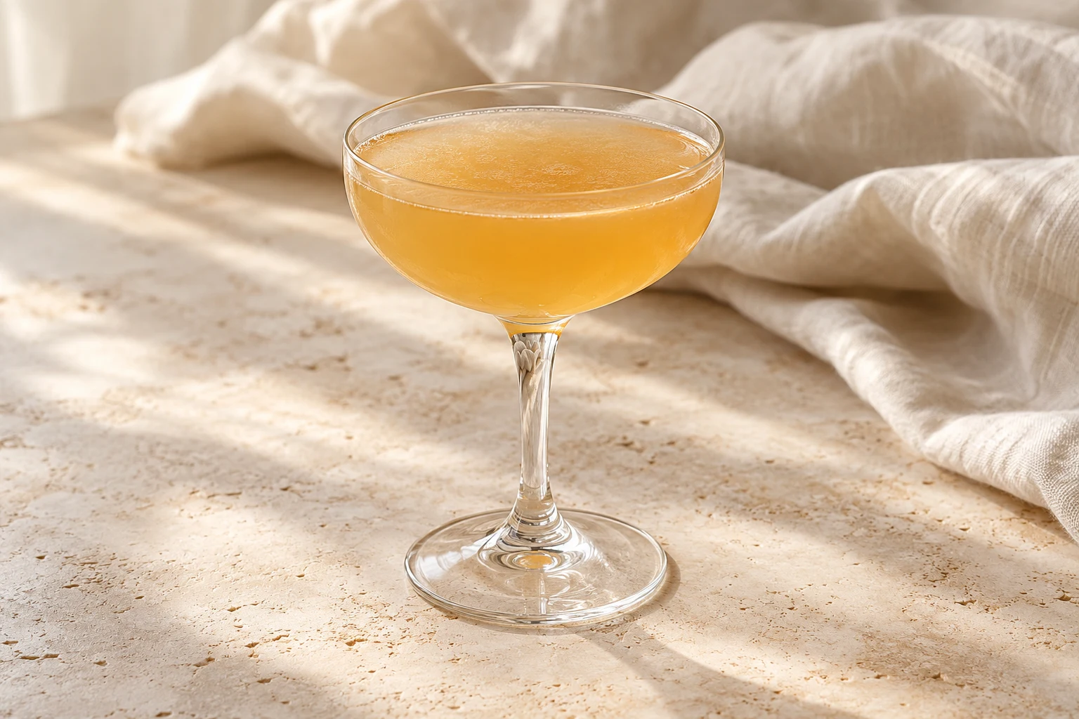 Pale amber-gold Sidecar in a plain stemmed coupe, slightly cloudy from lemon and without ice or garnish